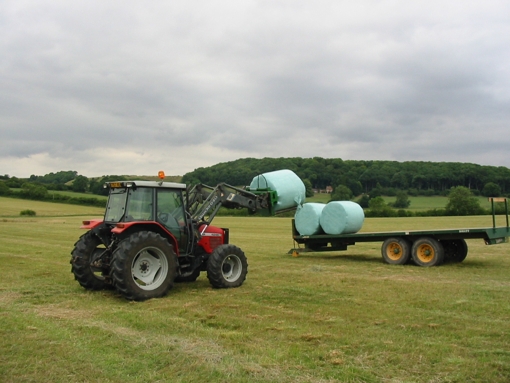 Loading wrapped silage bales to the trailer to take back to Tetford.